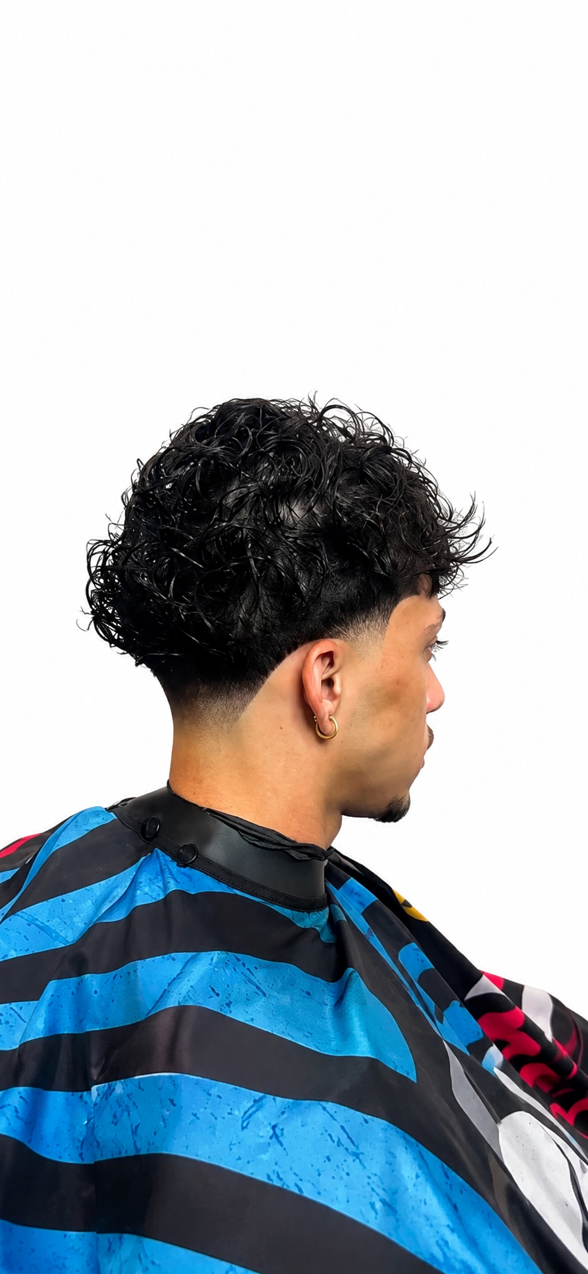 Curly top with clean taper fade — back view